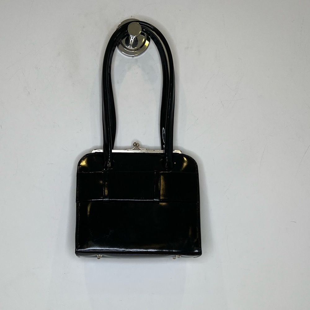 Anya Hindmarch black patent leather top handle, hard frame handbag.